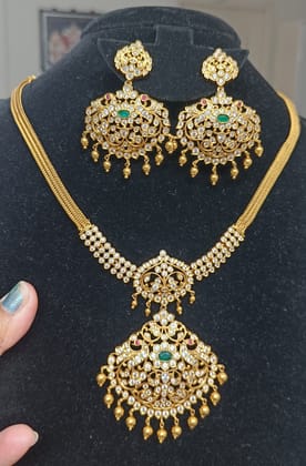 Mid Length Necklace in Gold Finish Petal Design Hanging Gold Balls in Pendent Beautifully Designed and Studded with White Stones and Pair of Matching Earrings