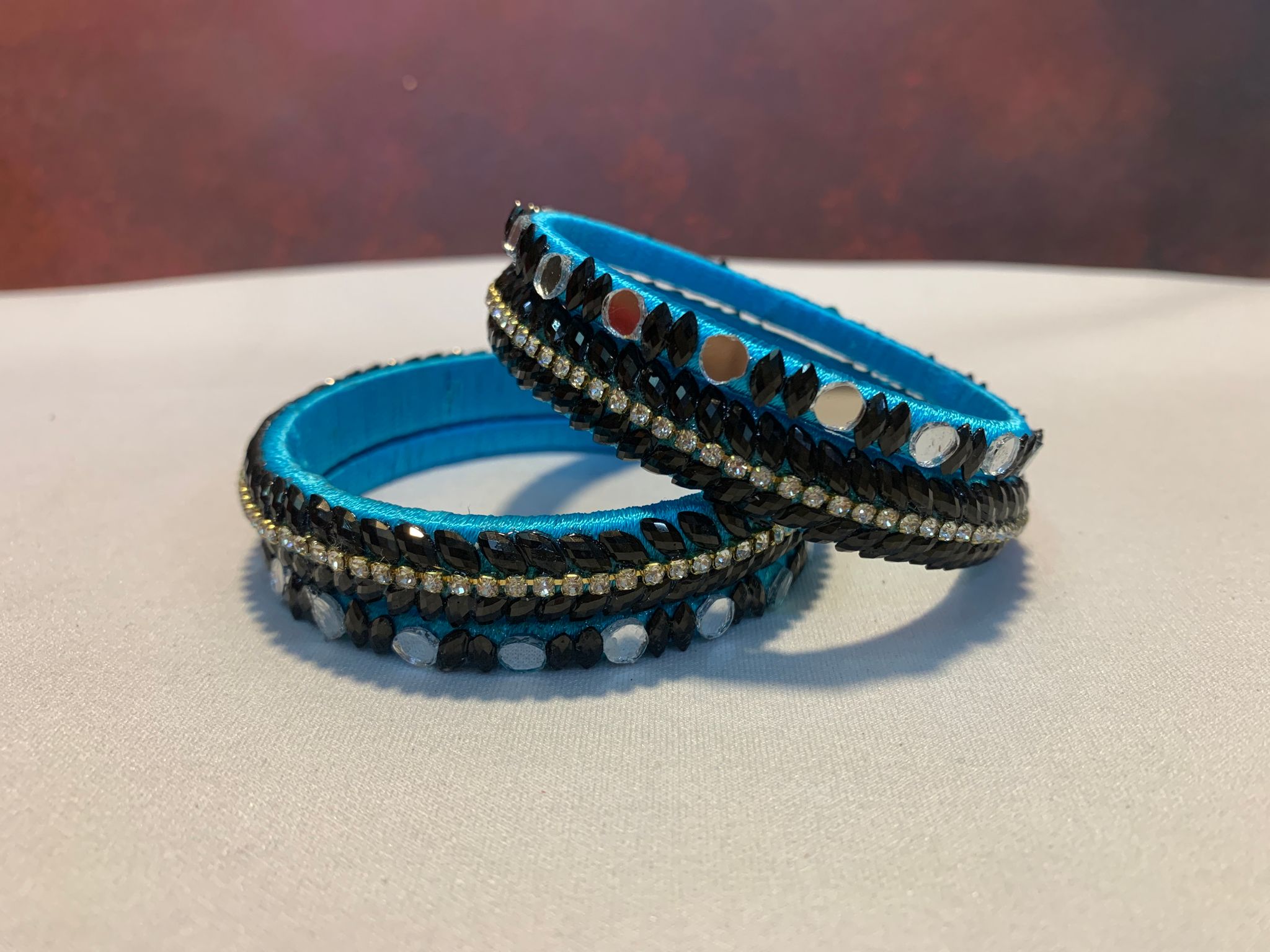 NVSB021- Sky blue with white and black stone silk thread bangle