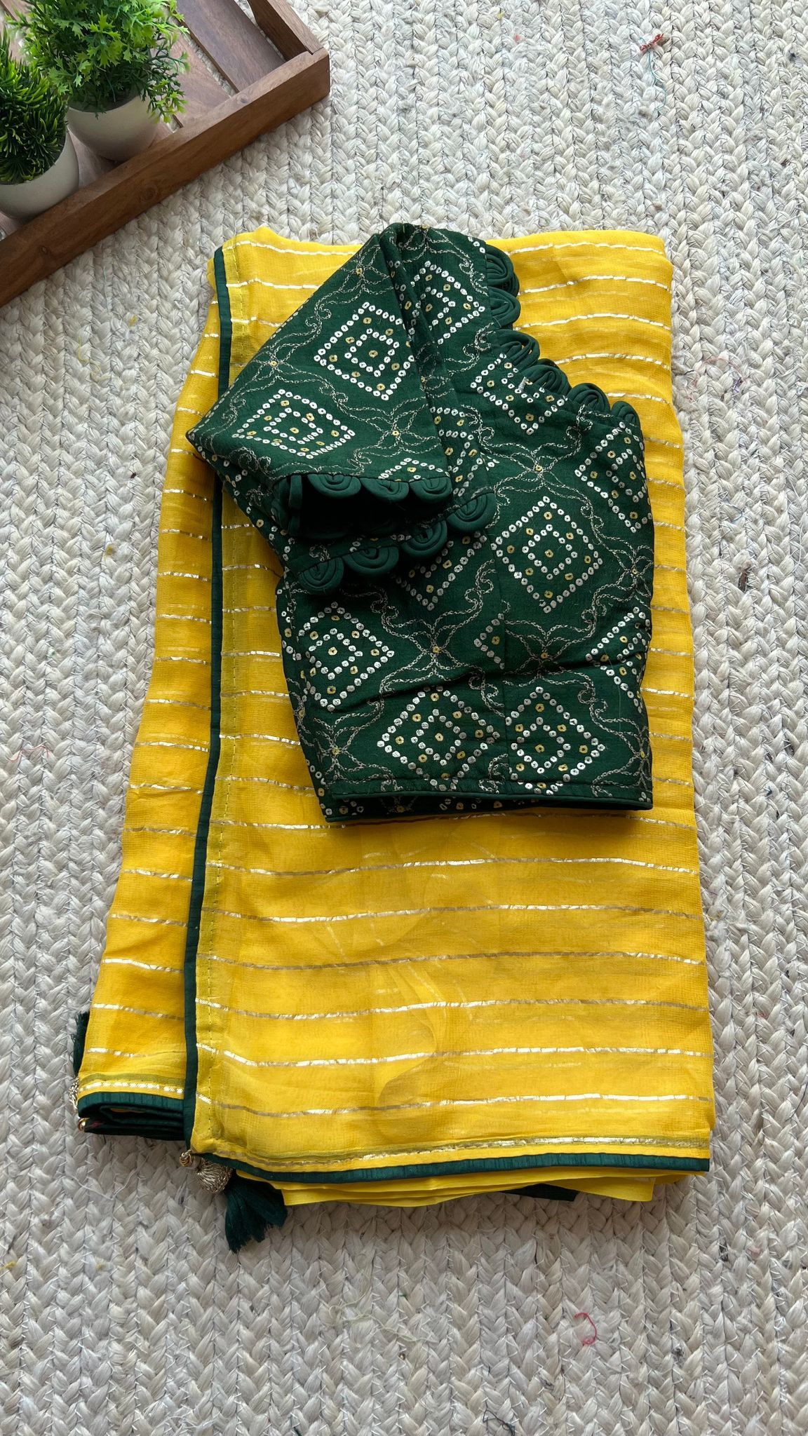 Yellow chiffon saree with green silk handwork blouse