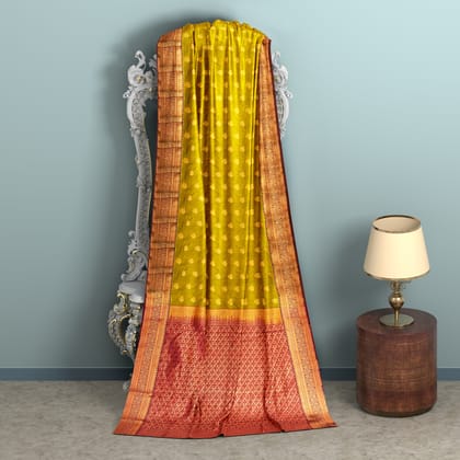 Yellow green body with Brown border 1000 buttas semi silk saree.