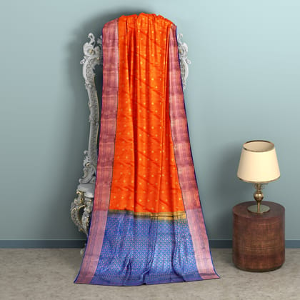 Warm orange body with  zari worked blue border 1000 buttas semi silk saree.