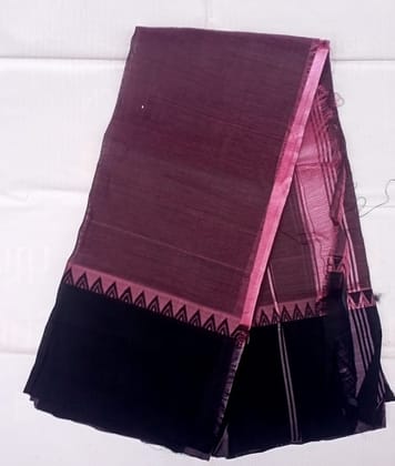  A beautiful handwoven cotton silk saree in a deep shade of aubergine with a black border featuring intricate geometric designs in zari. The saree is perfect for any formal occasion and will make you stand out from the crowd.