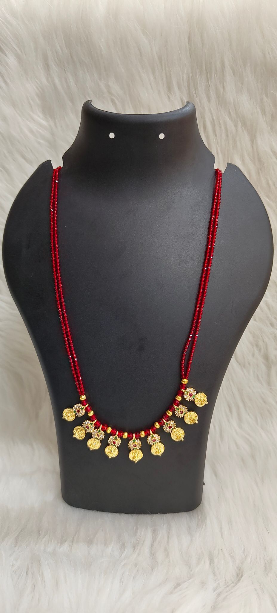 Delicate and elegant gold-plated long necklace with red beads and intricate detailing, perfect for any occasion.