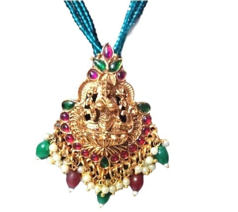 Traditional gold plated pendant necklace with intricate detailing and vibrant gemstones