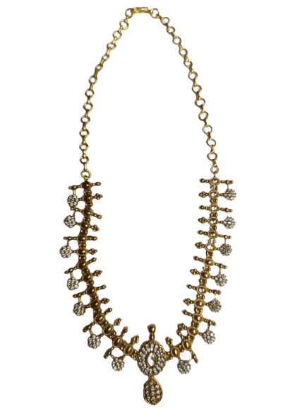 Gold-plated traditional Indian necklace with intricate detailing and white stones.