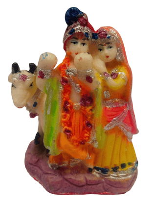 Colorful and intricate statue of Radha Krishna standing together with a cow