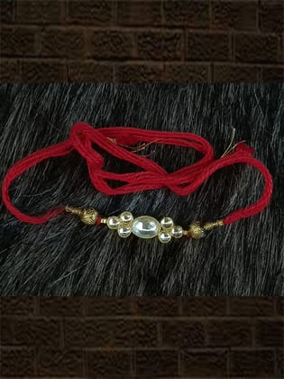 Elegant kundan rakhi in red and green thread with side gold beads-Red Thread