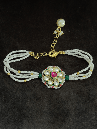 Pacchi kundan flower design bhabhi rakhi with ruby stone center