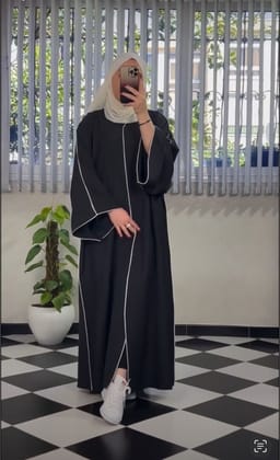 Black abaya with white piping.