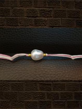 White bead rakhi in white and pink thread