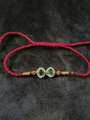 Pacchi kundan with pirohi rakhi in red thread-Green