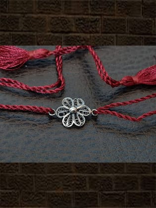 Maroon thread oxidised flower design sterling silver rakhi