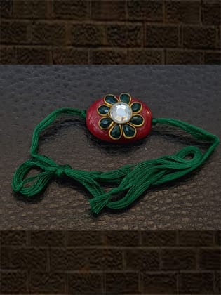 Red oval bead with green stone flower with green colour thread rakhi