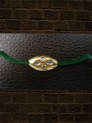 Oval gold bead green thread kundan rakhi