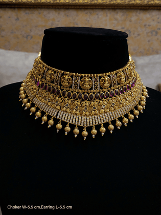 Broad zircon studded laxmi ji motifs choker with oval stones line and gold bead hanging-Ruby