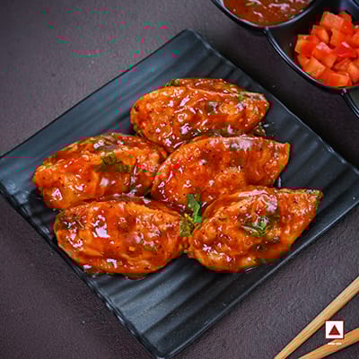 Chicken Pahari Feast Pan Fried Momo In Tomato Garlic Sauce